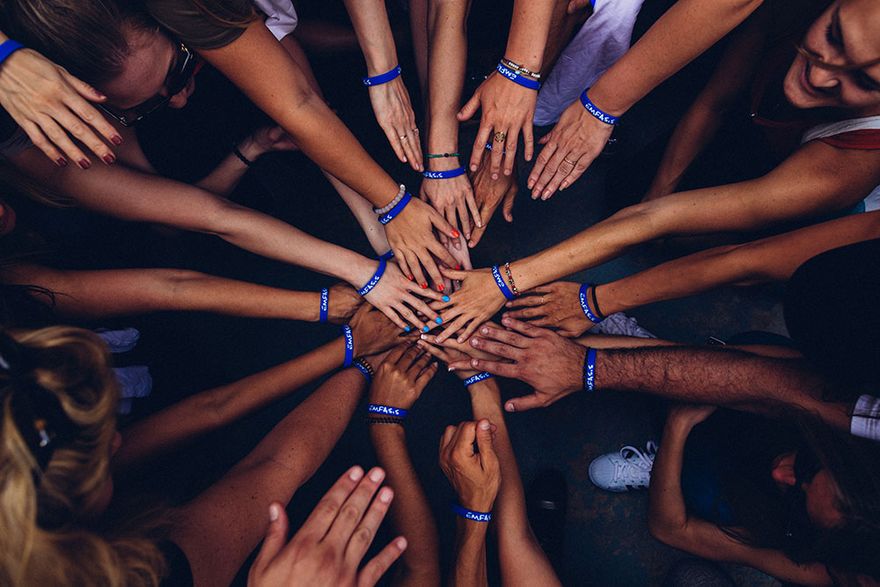 Hands in a group huddle