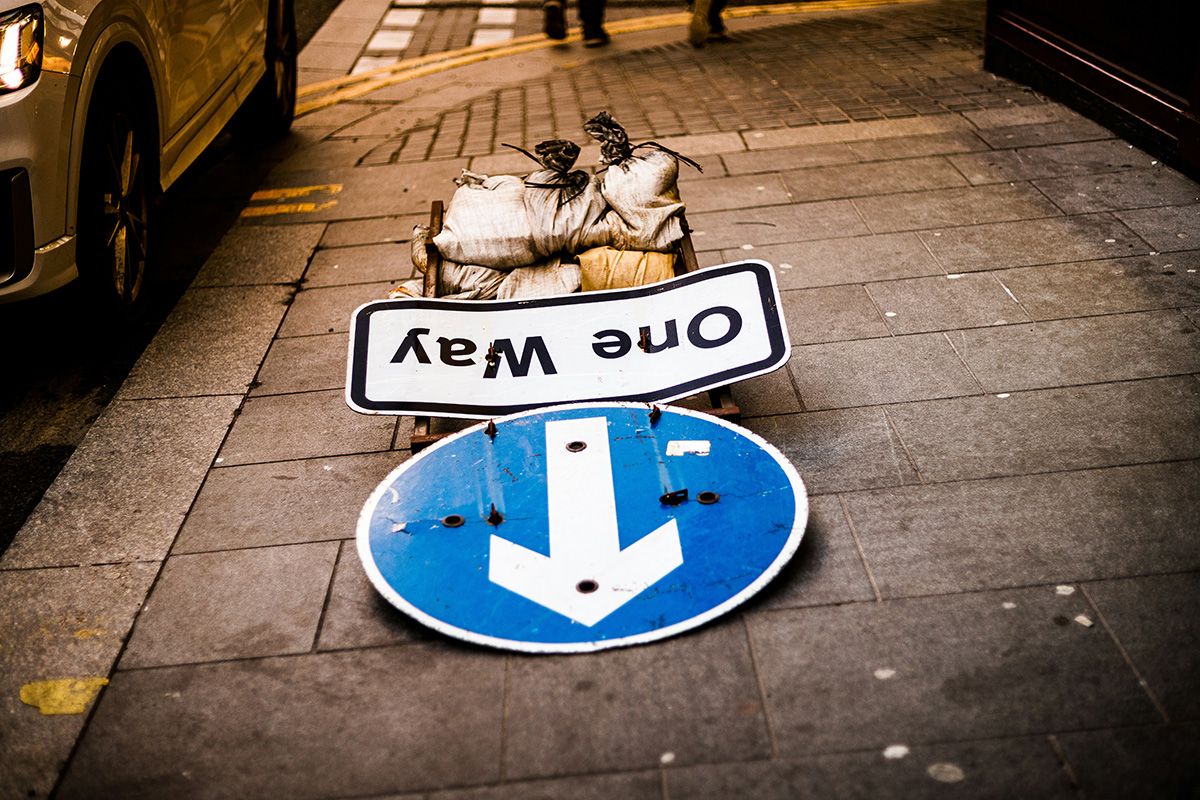 One way sign lying on the ground